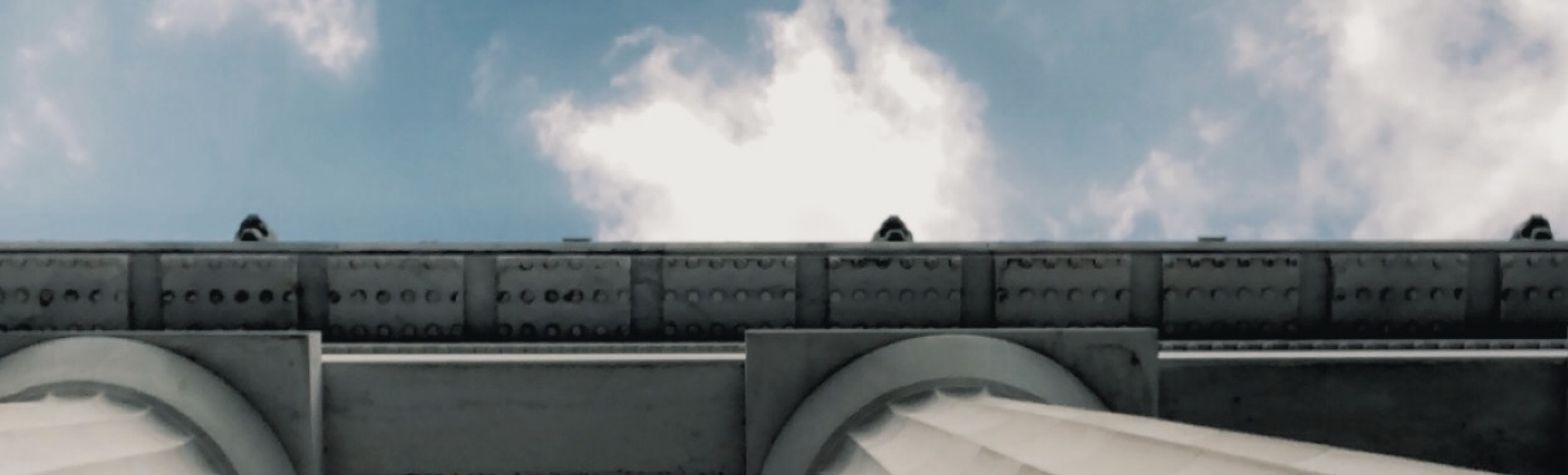 A low angle photo taken of where a summer sky meets the ceiling of the Lincoln Memorial.